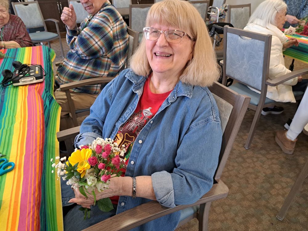Resident holding a fresh bouquet of flowers