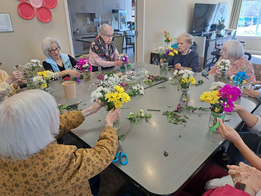 Residents arranging fresh flowers together