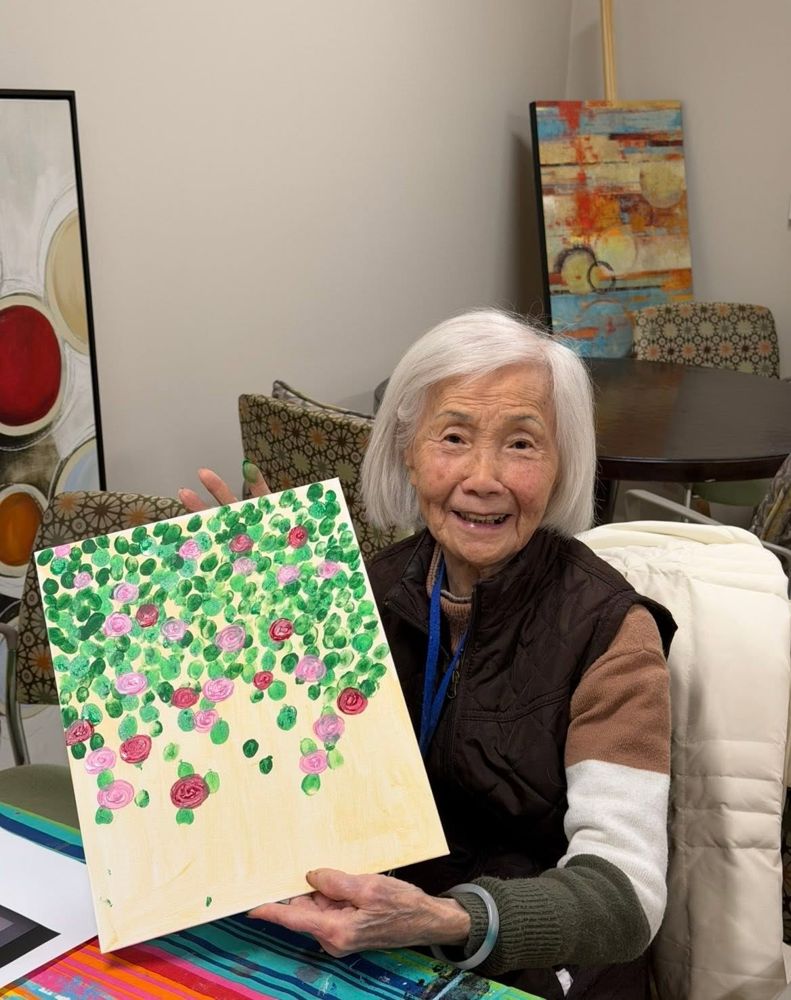 Resident proudly showing her painting