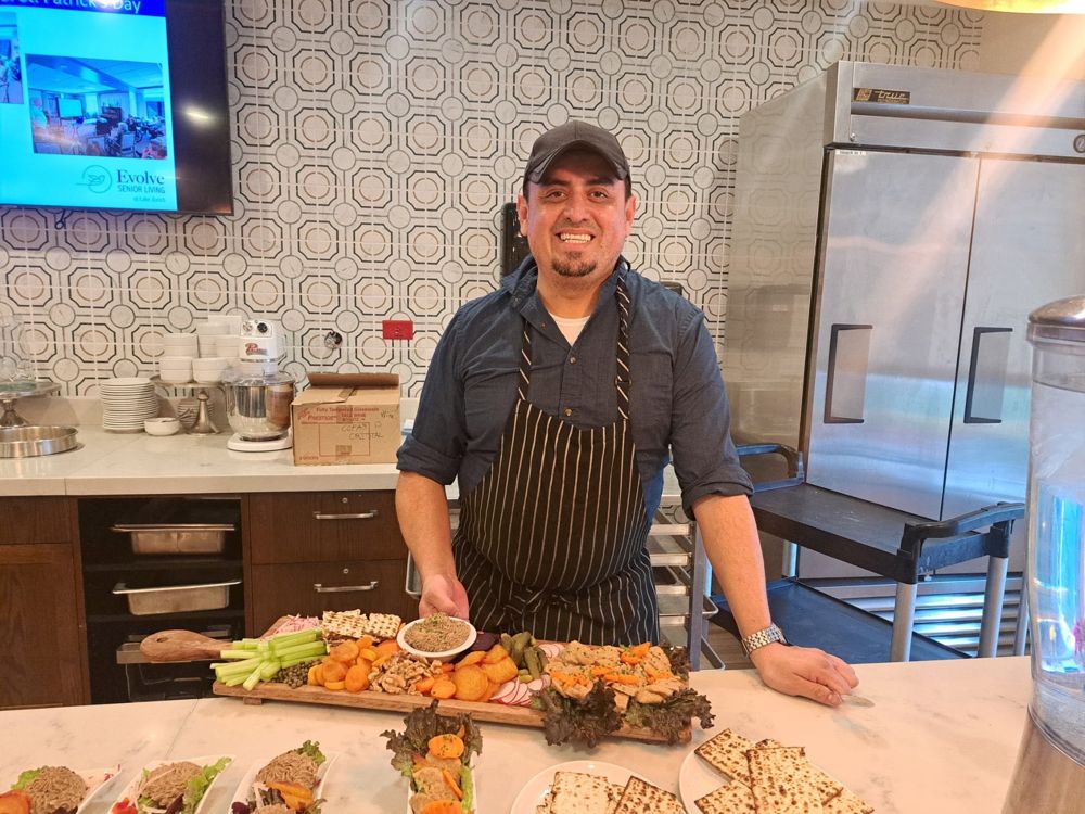 Chef presenting a charcuterie and appetizer board